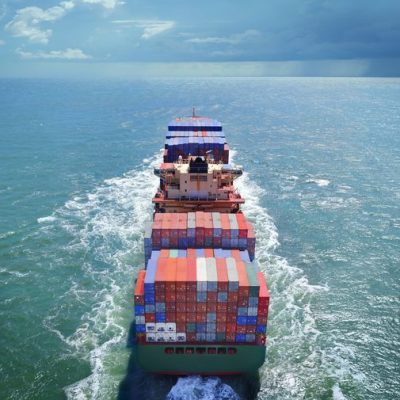 cargo ship at sea sailing towards horizon